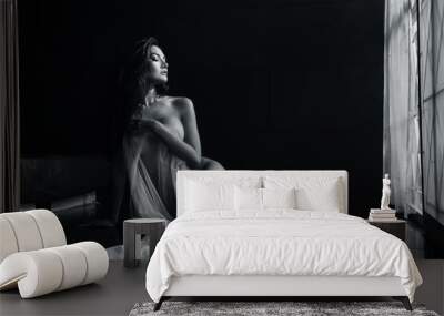 black and white young asian women model sitting poses naked by the window light only a thin curtain envelops her and dark background, lady sexy emotion of art Wall mural