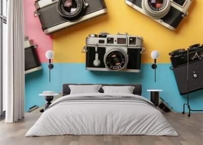 A collection of vintage cameras on a colorful background, ideal for a photography-themed retro banner Wall mural