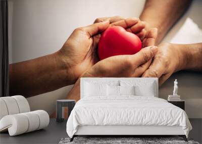 Helping hand of heart donor for patient in heart disease. Man give red heart to woman as couple. People lifestyle and couple romance. Healthcare and hospital medical concept. Symbolic of Valentine day Wall mural