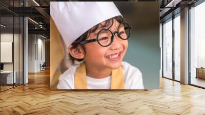 Portrait cute little Asian happy boy interested in cooking with mother funny in home kitchen. People lifestyles and Family. Homemade food and ingredients concept. Baking Christmas cake and cookies Wall mural