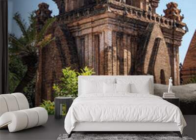 Old sacred red brick tower and two large grey stones Wall mural