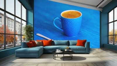 Coffee mug on a wooden turquoise background. Wall mural