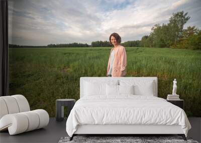 Portrait of a young beautiful fair-haired girl in nature. Wall mural