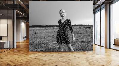 Portrait of a young beautiful girl on a horse farm. Black and white photo. Wall mural