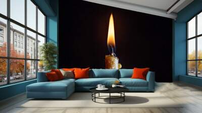 The flame of a dying candle on a dark background. Wall mural