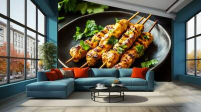 A detailed close-up of a plate of savory chicken satay skewers with peanut sauce. Wall mural