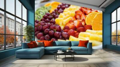 Fruit platter with various types of fruits arranged on a white plate Wall mural