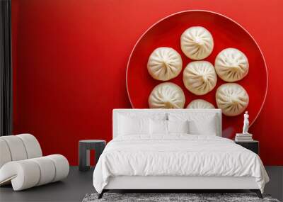 Steamed pork bao dumplings served on a red plate, isolated against a red background. Chinese new year concept Wall mural