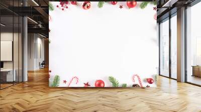 Christmas background concept. Top view of Christmas green gift box with candy cane, snowflakes, red berries and bell on white wooden background. Wall mural