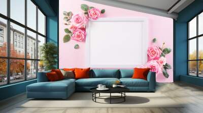 Happy women's day concept, pink roses with white picture frame on pastel background Wall mural