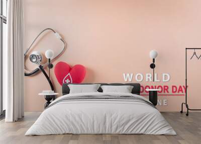 Medical and donor concepts. Doctor stethoscope and a handmade red heart with a sign or symbol of blood donation for world blood donor day with the text. Wall mural