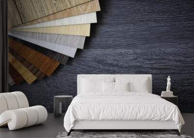 Laminate Wood Concept - Sample pack of wooden flooring laminate on wooden black floor Wall mural