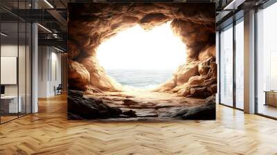 A cave opening with a view of the ocean and bright light illuminating the interior. Wall mural