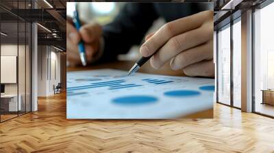 A person analyzing graphs and charts on a document. Wall mural