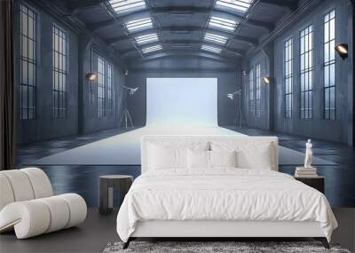 A spacious studio with a white backdrop and industrial lighting. Wall mural