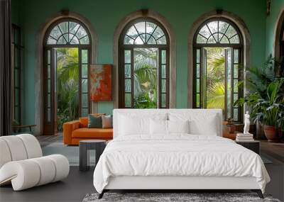 A vibrant living room featuring an orange sectional sofa and large windows with greenery. Wall mural