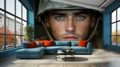 Close-up portrait of a soldier in a helmet, conveying determination. Wall mural