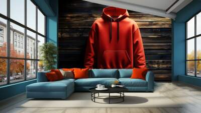 A vibrant red hoodie displayed against a wooden background. Wall mural