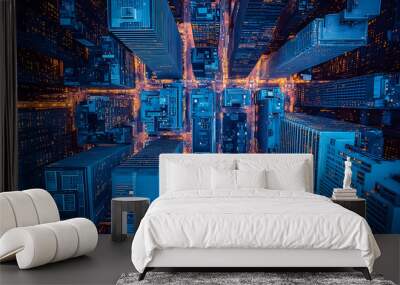 An aerial view of a city at night, with tall buildings and bright lights. Wall mural