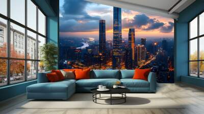 An aerial view of a modern city skyline with skyscrapers at sunset. Wall mural