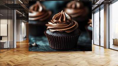 Close-up of a chocolate cupcake with swirls of chocolate frosting and chocolate chips on a dark background. Wall mural