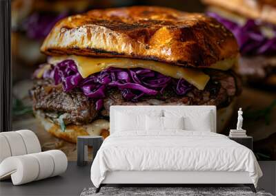 Close-up of a juicy beef burger with red cabbage, cheese, and sauce on a toasted bun. Wall mural