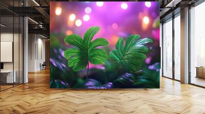 Two large green leaves in front of blurred colorful lights. Wall mural