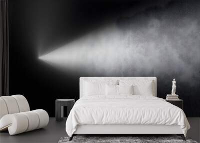 A beam of light illuminating a textured surface in darkness. Wall mural