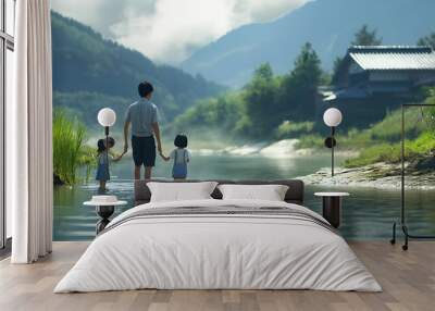 Family Wading Through River with Mountain Views and Traditional House in the Background Wall mural