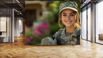 Smiling soldier in uniform stands outdoors with flowers in background. Wall mural