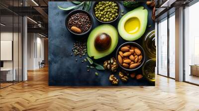 Top view of healthy fats avocado, almond, flax seeds, walnut and oil. Wall mural