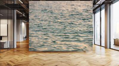 a small light ripples in the water green hue with reflection sunset Wall mural