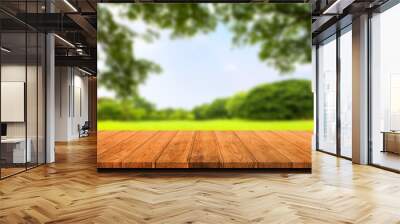 Empty wooden table isolated on blurred green nature background. For your product placement or montage with focus to the table top in the foreground. Empty wooden brown shelf. shelves Wall mural