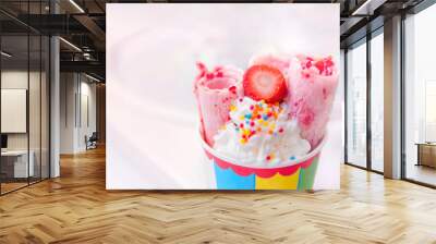 ice cream rolls with strawberries in a paper color cup on a white background. strawberry ice cream.  Wall mural