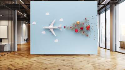 Christmas composition. Airplane flying in sky star gift bauble top view background with copy space for your text. Flat lay Wall mural