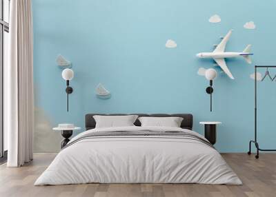 White top view Airplane . Sailboat clouds beach blue cloud sky background with copy space for your text. Flat lay. Wall mural