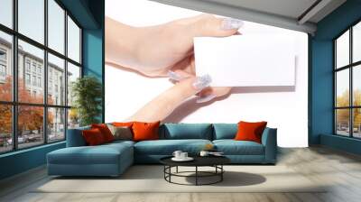 blank visiting card on woman's hand Wall mural