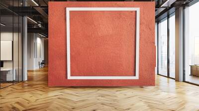 Square white frame on red bronze wall background. Side view. Creative concept, copy space. Wall mural