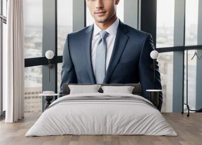 young business man with wearing a suit standing near modern window office Wall mural