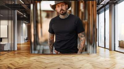 Handsome male in cowboy hat wearing blank black t shirt as a mockup for printing Wall mural