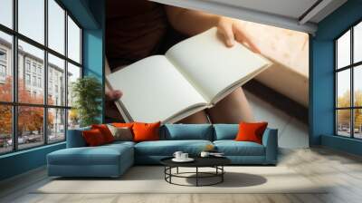 Woman reading blank book Wall mural