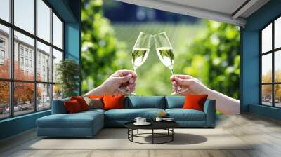 toasting with two glasses of champagne in the vineyard Wall mural