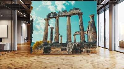 The ancient ruins of a Greek temple stand tall against a backdrop of blue sky and white clouds. Wall mural