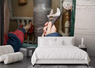 Hands of plumber using wrenches while repairing pipes, close up view. plumber woman worker with spanner installing water meter Wall mural