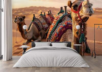 Embark on a visual adventure as a caravan of camels traverses the expansive desert landscape, with vast stretches of sand and distant dunes creating a mesmerizing scene of ancient nomadic travel Wall mural