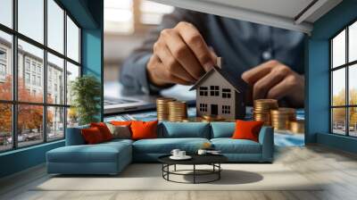 Visualize an image depicting the real estate investment concept, featuring a man interacting with a virtual house icon to analyze mortgage loans, home insurance, and real property mortgages Wall mural