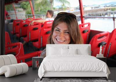 Girl sitting on a double decker red bus in Panama City douring a bus tour. Wall mural