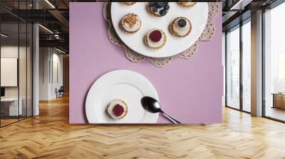 Sweet tartlets filled with cream and blueberry, raspberry and ma Wall mural