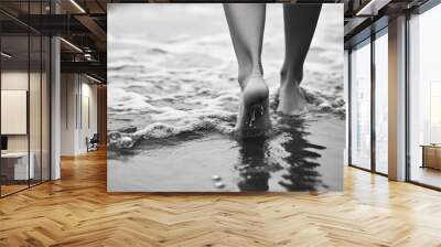 Woman's feet walking in surf, close-up photography, black and white, heavy depth of field effect  Wall mural