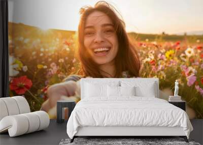 Beautiful girl taking a selfie in a blooming flower meadow in summer or late spring. Close-up of a happy woman. Wall mural